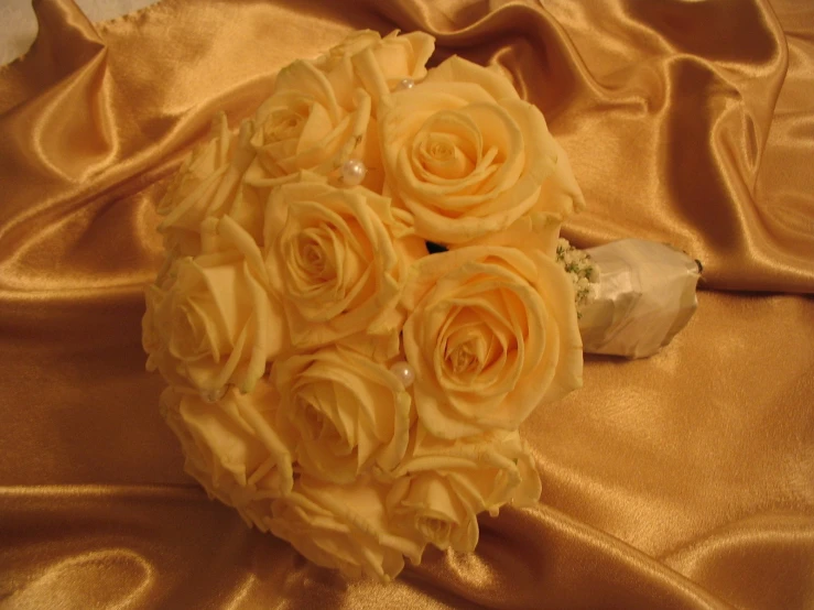 a bridal bouquet of yellow roses and a rose