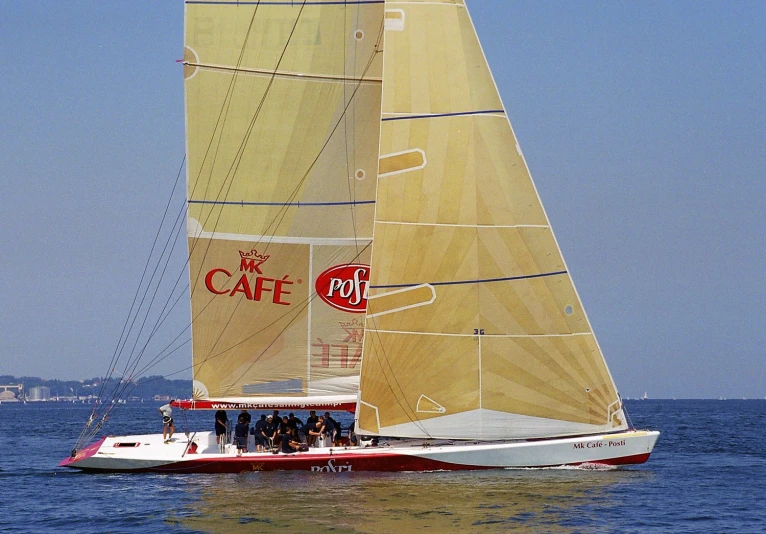 a sailboat is in the water with people on it