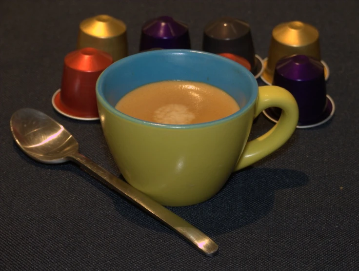 an array of cups of  beverages are sitting on the table