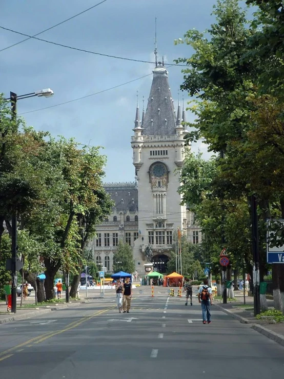 a street with buildings with a clock tower in the middle of it