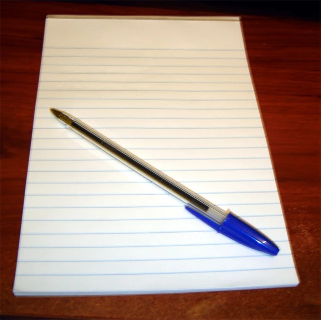 a notepad that has a pen on it