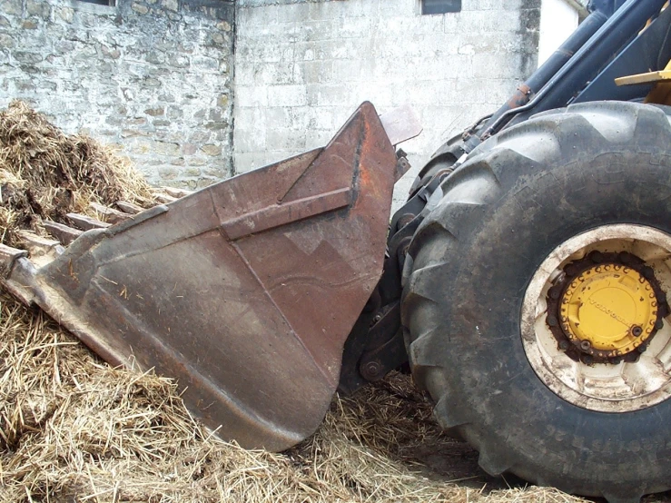 large tractors dumping hay to the side