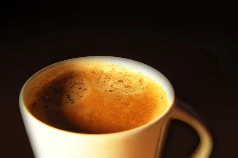 the coffee mug is filled with steamy liquid