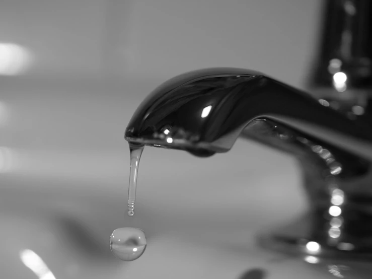 a close up of the water running from a sink