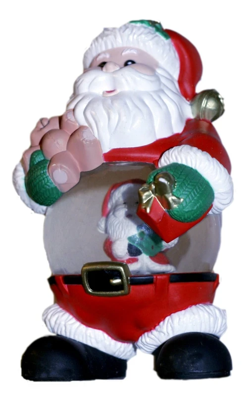 a ceramic santa with a bell in his hands