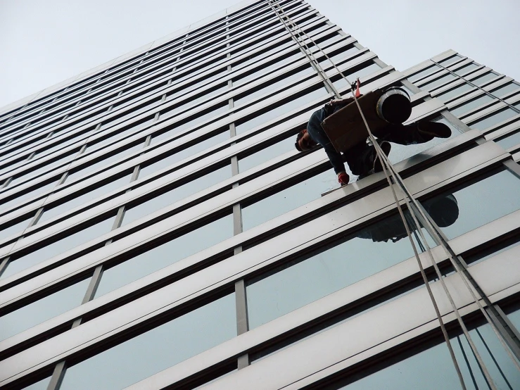 a person on a high rope next to a building