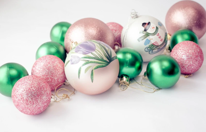 christmas decorations are scattered around with shiny gold and green ones