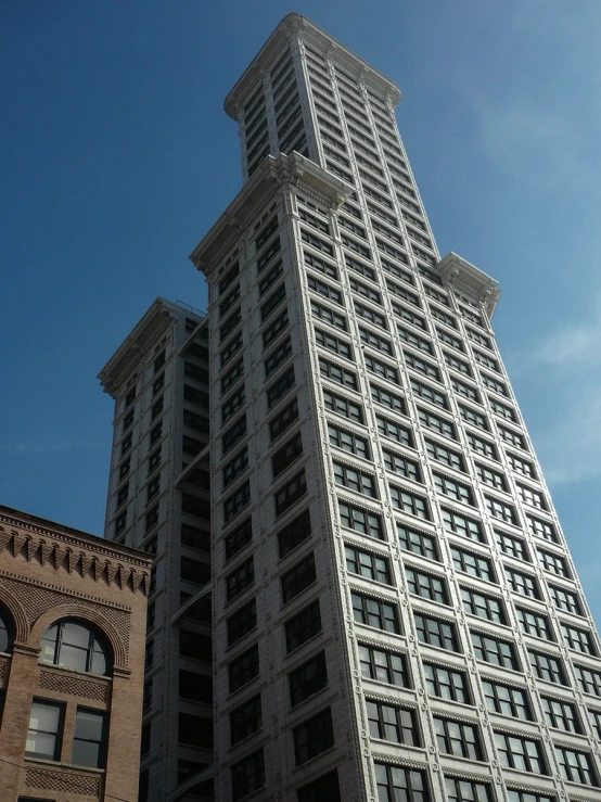 looking up at a tall grey building with windows on the side