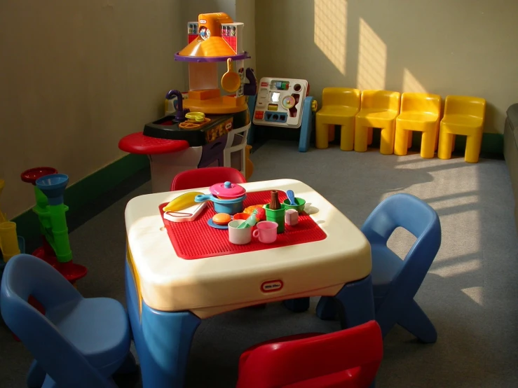 a child's play table set up inside of a playroom