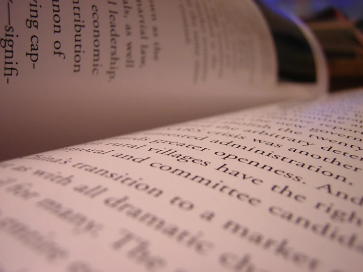 closeup of a book open with black and white lettering
