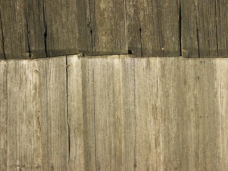 an old fence is wooden and shows very faded woodgrains