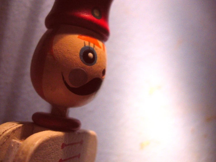 a wooden toy man with an expression that is drawn on