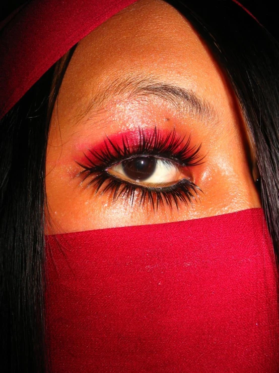 an image of a woman with red eye makeup
