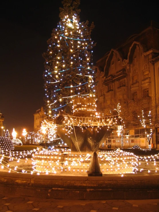 a christmas tree that is on display in front of a building