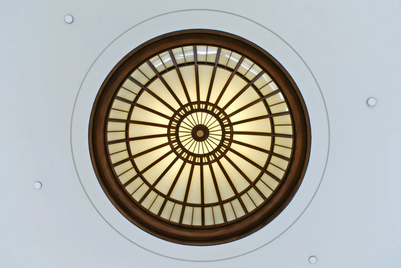 a ceiling that has a circular glass window in it