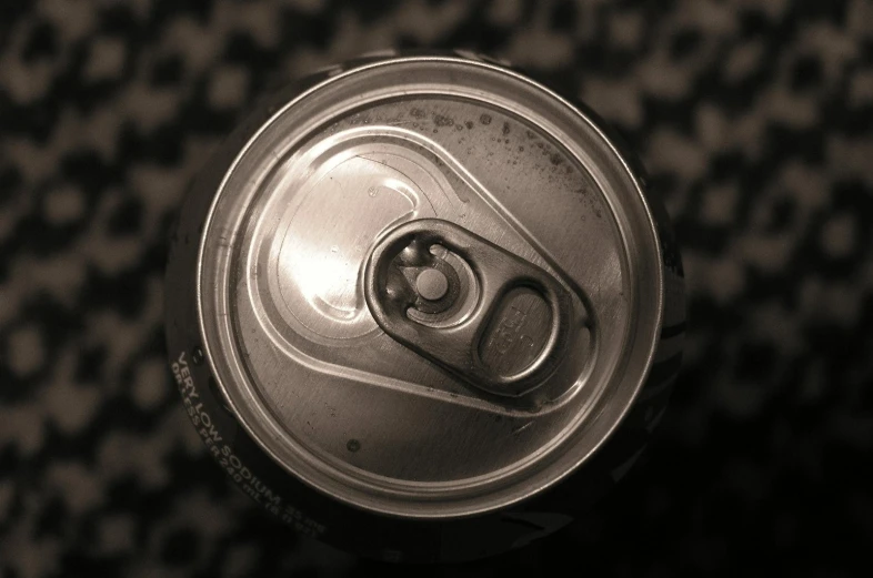 a soft drink can lying open on a chair