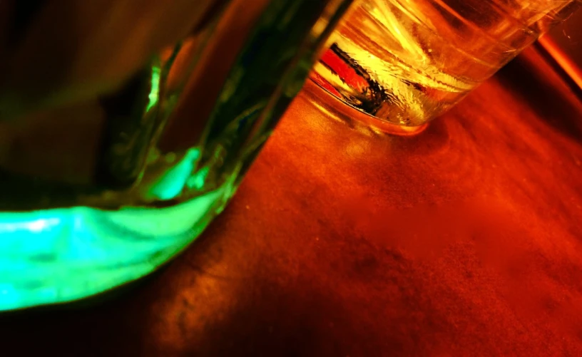 a glass with some liquid in it sitting on a table