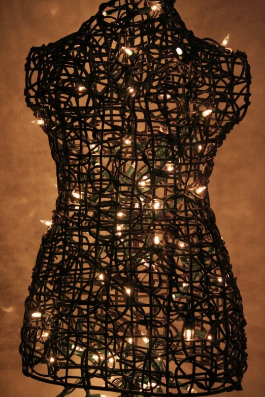 a mannequin is covered with christmas lights for display