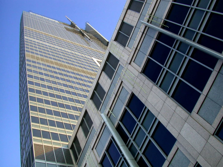 an airplane flying over a tall building with windows