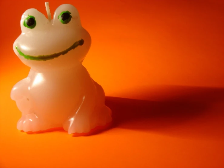 an orange surface with the light turned green and the figure with a frog face is on top