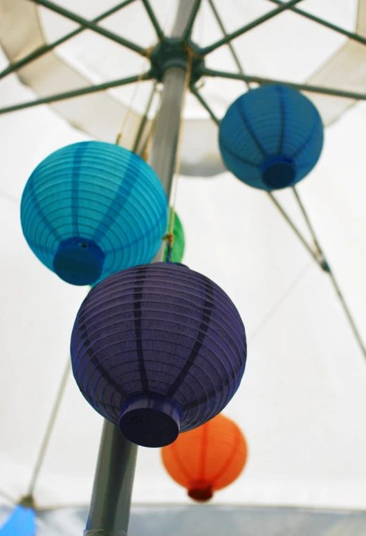 some lights hanging from a metal pole under a canopy