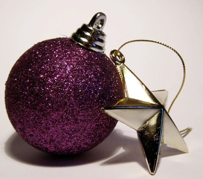 a purple christmas ornament with a silver star hanging from it