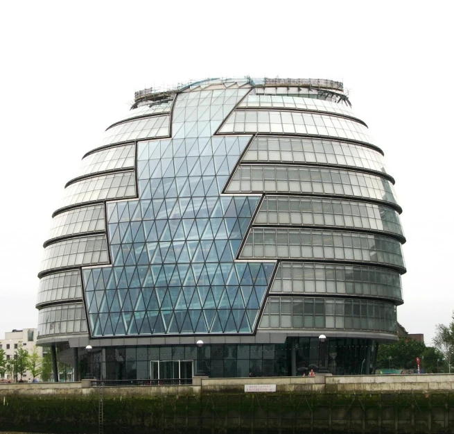 the building is glass and is designed to look like an abstract shape