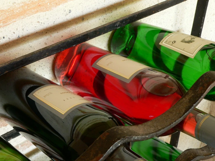 many different types of wine sitting inside of bottles