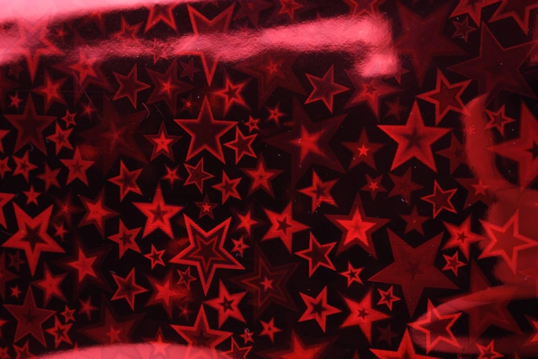 star shaped glass with red stars on a window