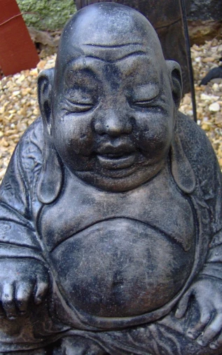 a statue of buddha that looks like he is in a sitting position