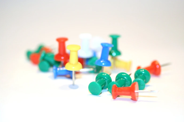 a group of colored pins and ons are shown