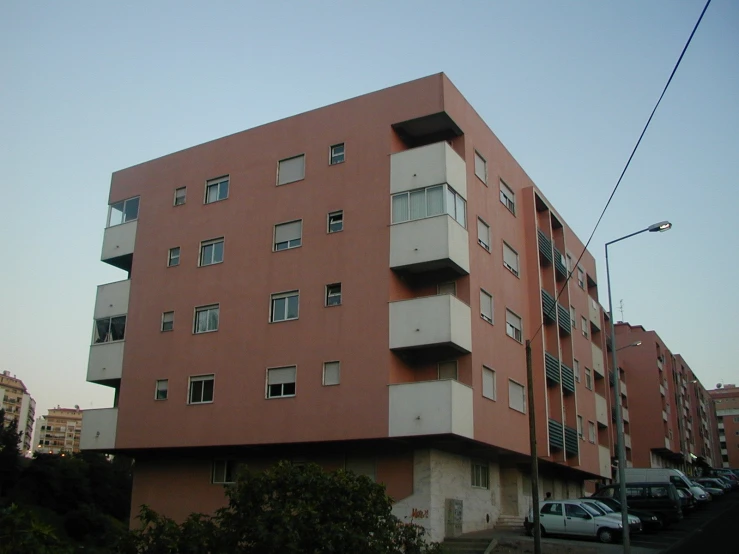 an apartment building with several balconies and a second floor
