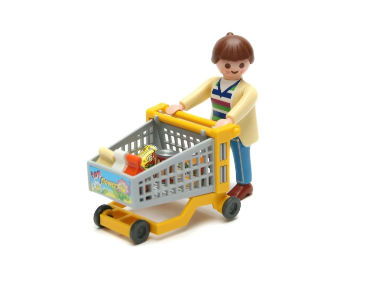 a toy person hing a grocery cart with toys in it