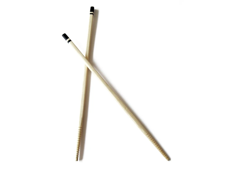 two wooden matches, one black, one white, are on a white surface