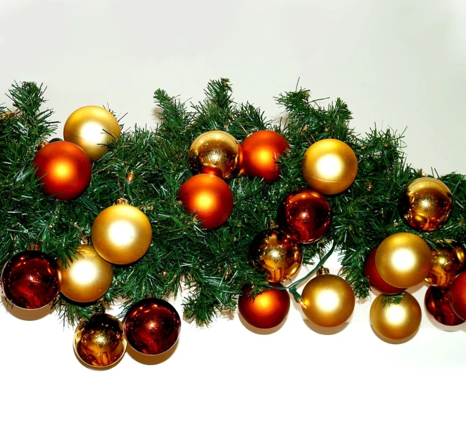 a pile of golden and red ornaments sitting on top of a white counter