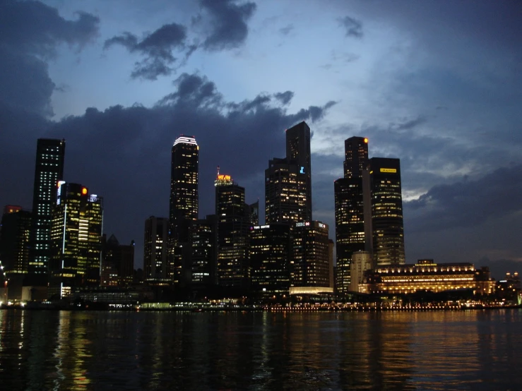 a night view of a city skyline with skyscrs and lights