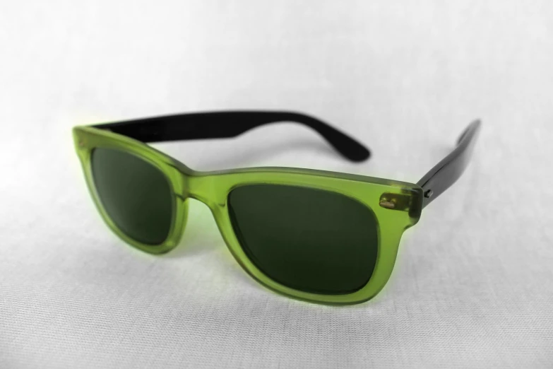a green pair of glasses with black handles