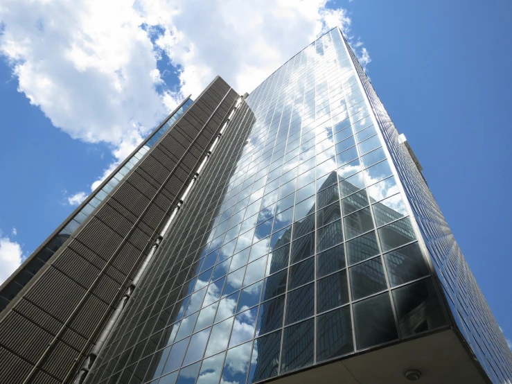 a skyscr building stands tall against a cloudy sky