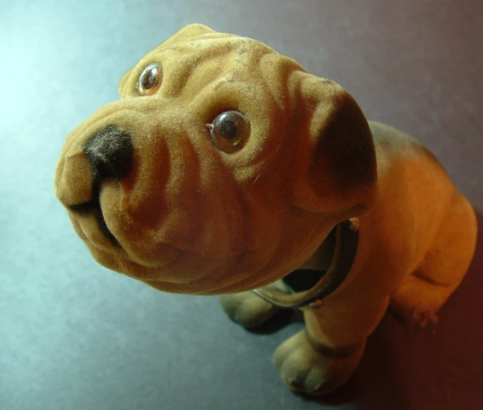 a stuffed dog is posed in front of the mirror