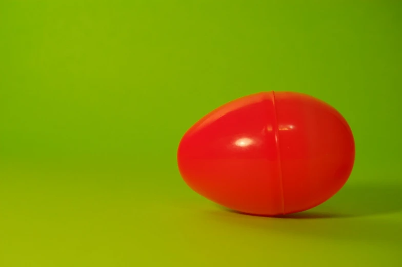 the red object has a green background and it's color