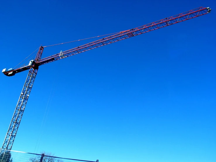 a large crane is attached to a wire