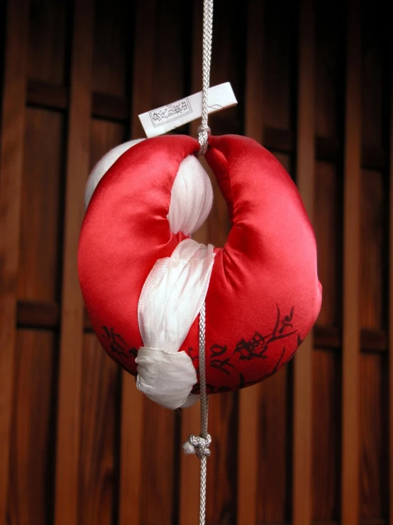 red and white ring shaped pillow hanging from a pole