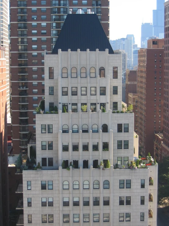 an apartment building in the city has windows and a black roof