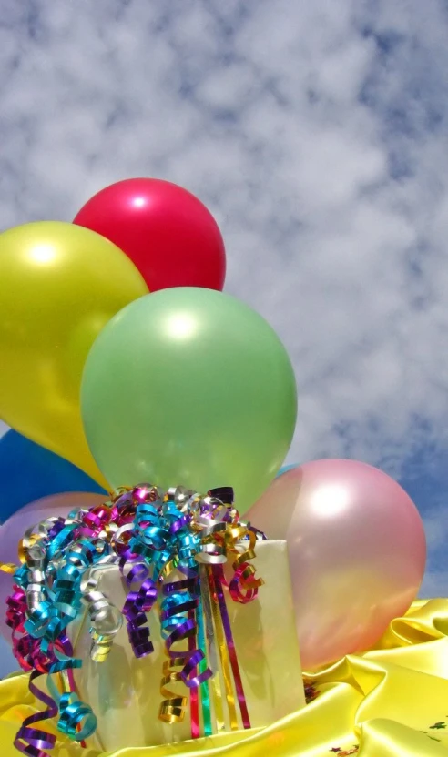 balloons with streamers sitting on top of a table