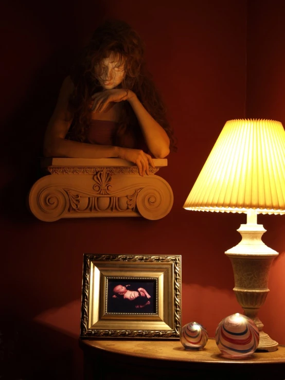 a small table is sitting on the floor near a lamp and a painting