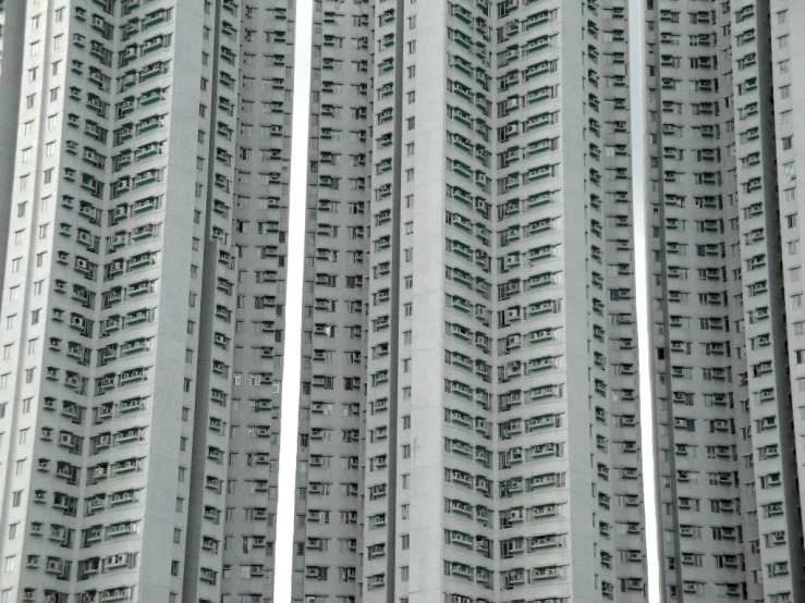 several tall, white buildings rise into the sky