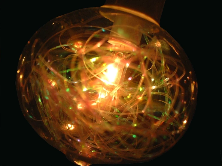 a glass vase with lights inside it