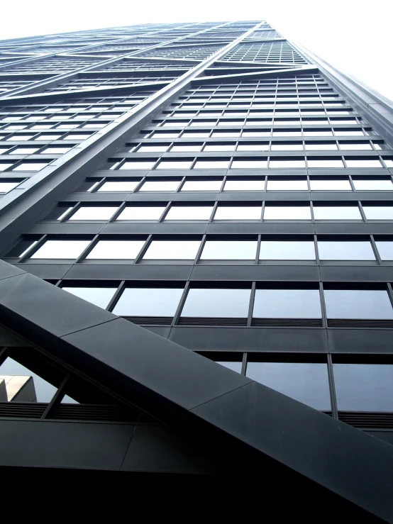 a tall building with very long windows against the sky