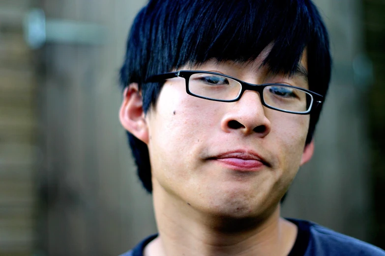 a young man with glasses on his face