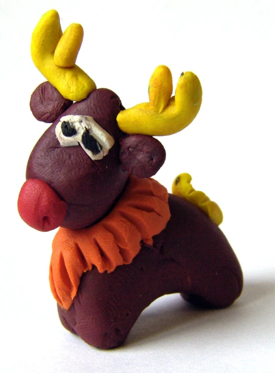 a clay deer with a large mustache and yellow antlers